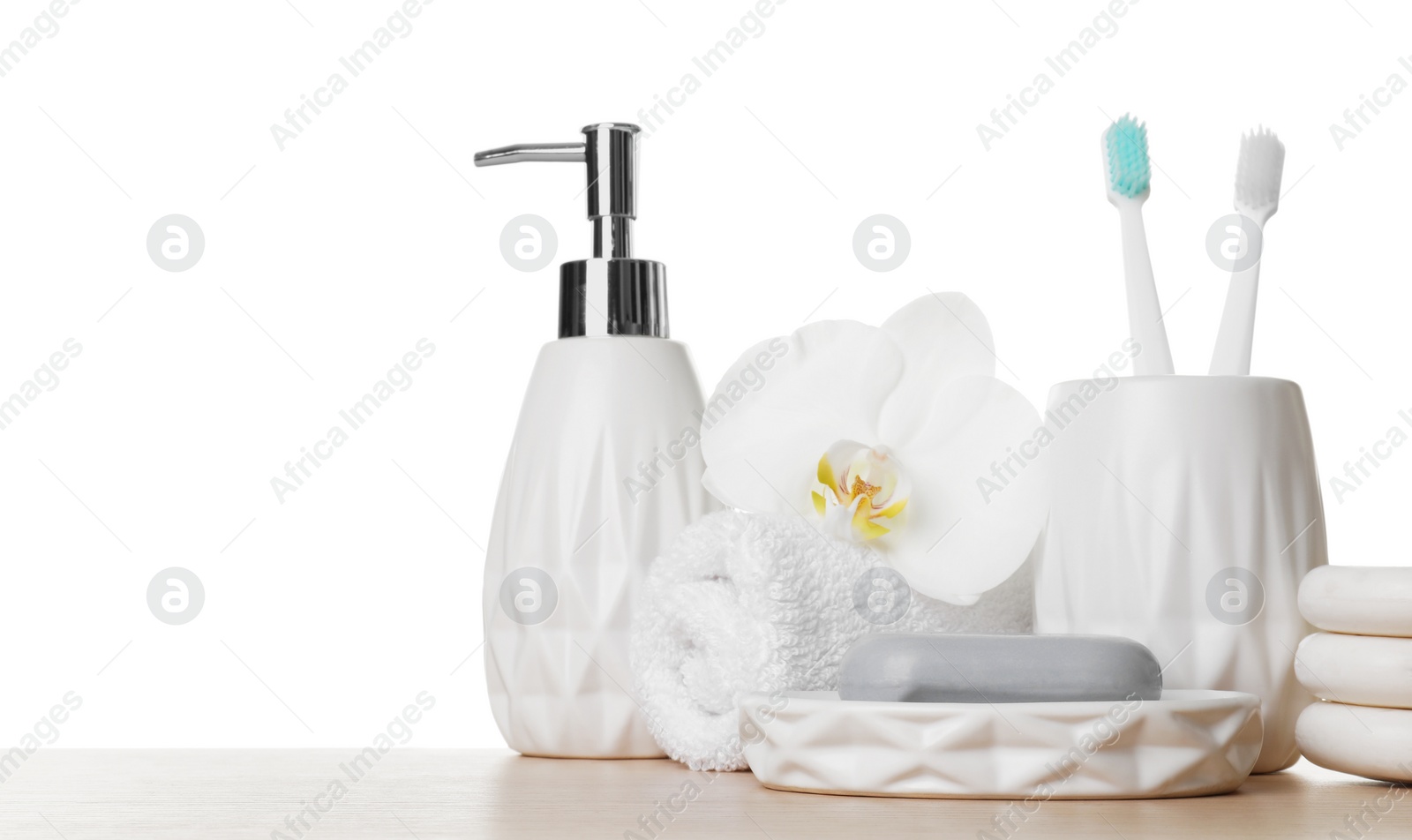 Photo of Bath accessories. Different personal care products and flower on wooden table against white background. Space for text