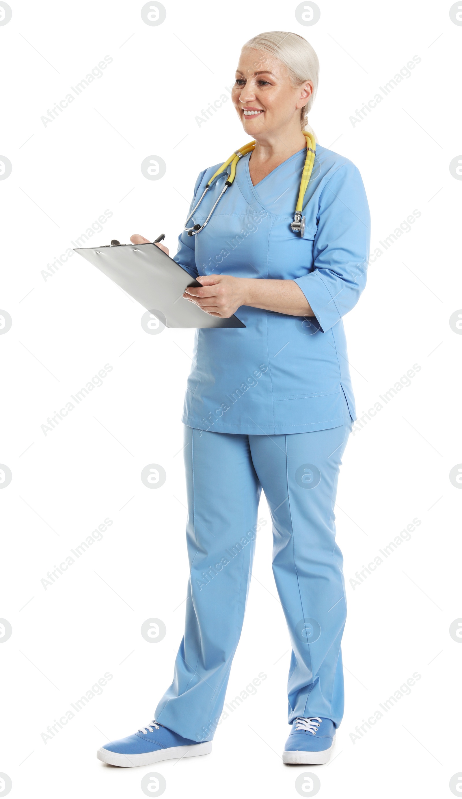 Photo of Full length portrait of female doctor in scrubs with clipboard isolated on white. Medical staff