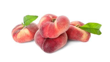 Photo of Fresh ripe donut peaches with leaves on white background