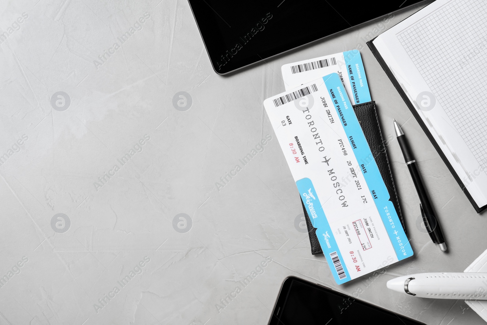 Photo of Flat lay composition with tickets on grey table, space for text. Travel agency concept