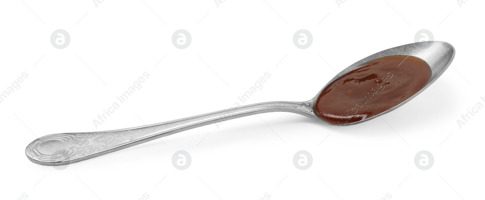 Photo of Tasty barbecue sauce in spoon isolated on white