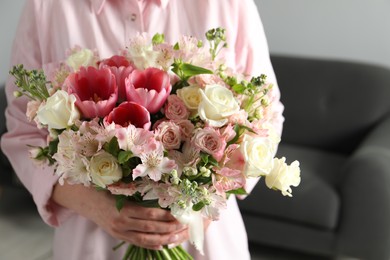 Woman with beautiful bouquet of fresh flowers indoors, closeup