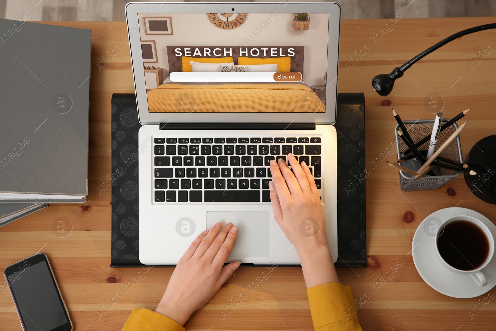 Image of Woman searching hotel using laptop at table, top view. Booking online service