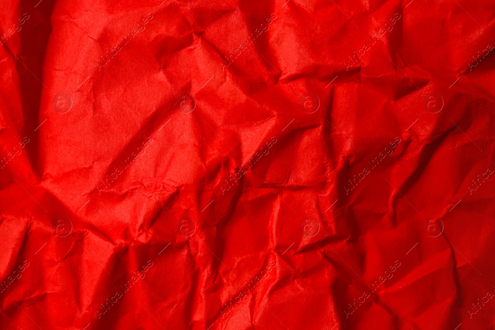 Photo of Sheet of crumpled red paper as background, top view