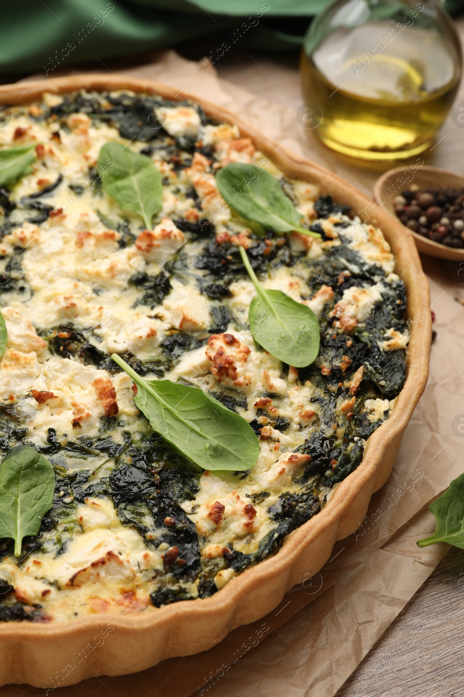 Photo of Delicious homemade spinach quiche on table, closeup