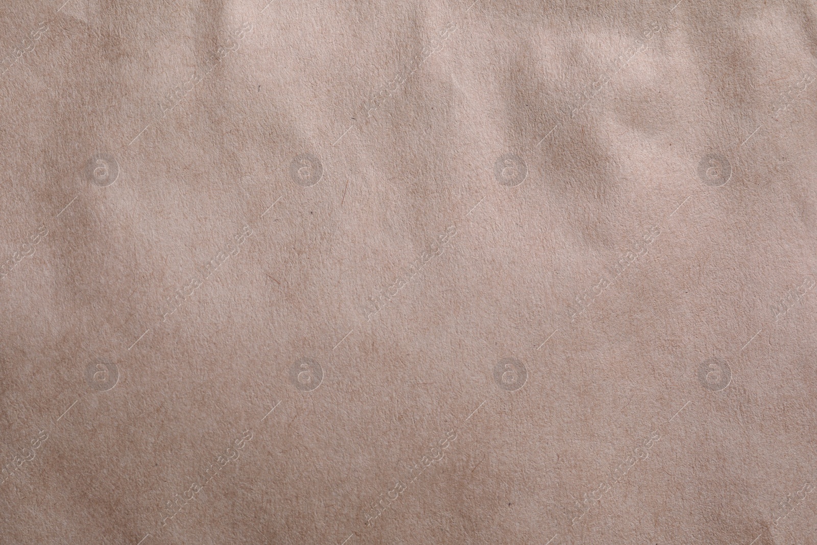 Photo of Texture of kraft paper bag as background, closeup