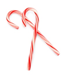 Tasty candy canes on white background. Festive treat