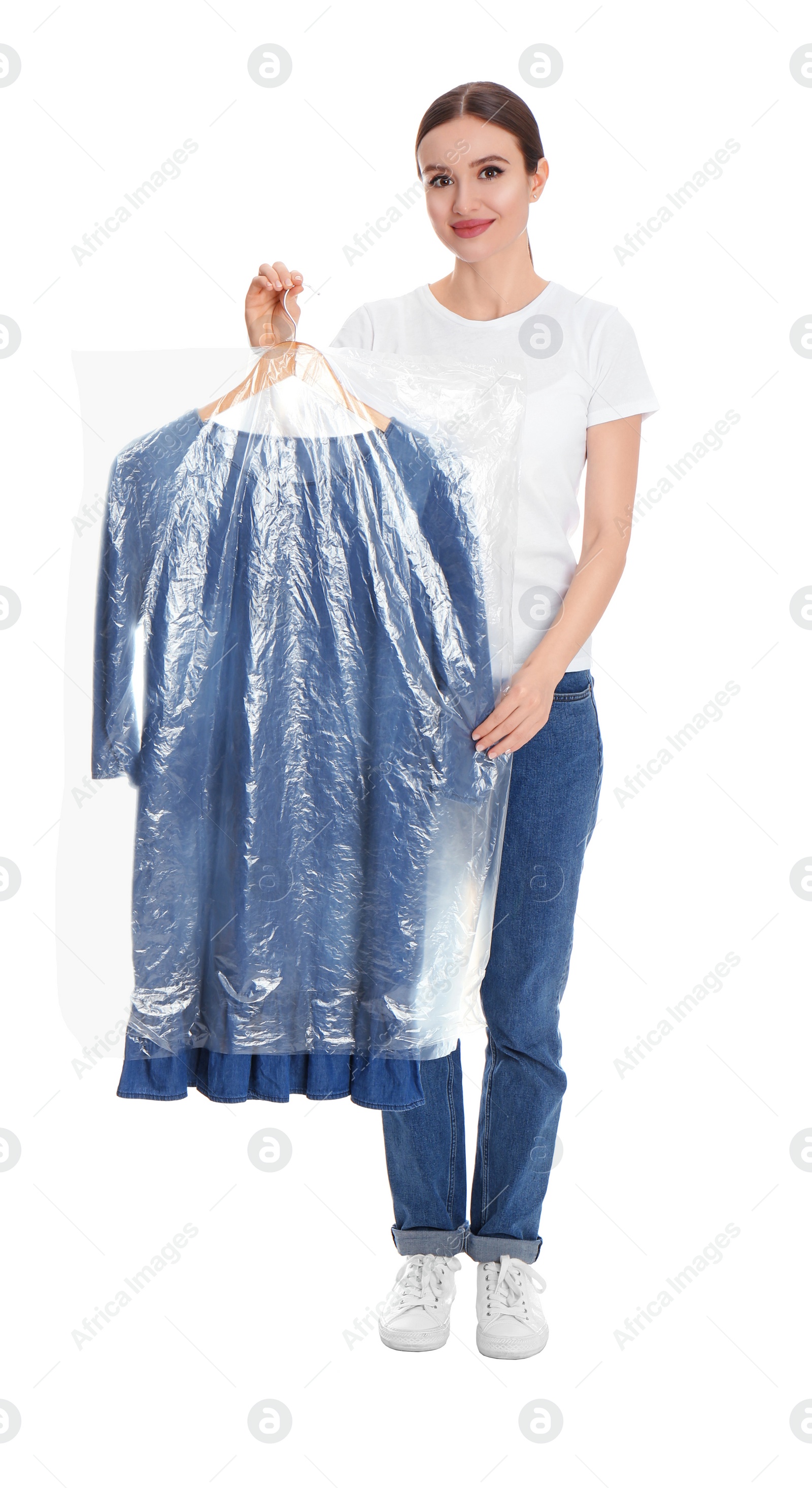 Photo of Young woman holding hanger with dress on white background. Dry-cleaning service