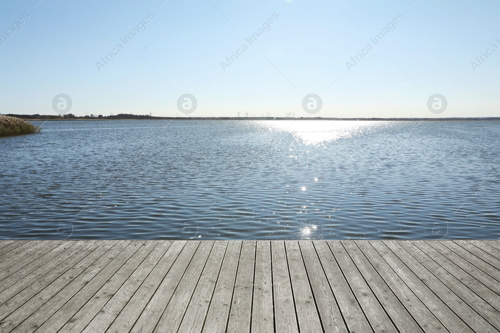 Photo of Beautiful view of wooden terrace near river on sunny day