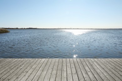 Photo of Beautiful view of wooden terrace near river on sunny day