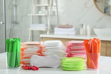 Photo of Different feminine hygiene products on table in bathroom