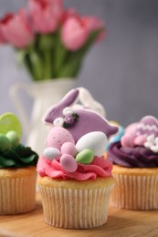 Tasty decorated Easter cupcakes on wooden table