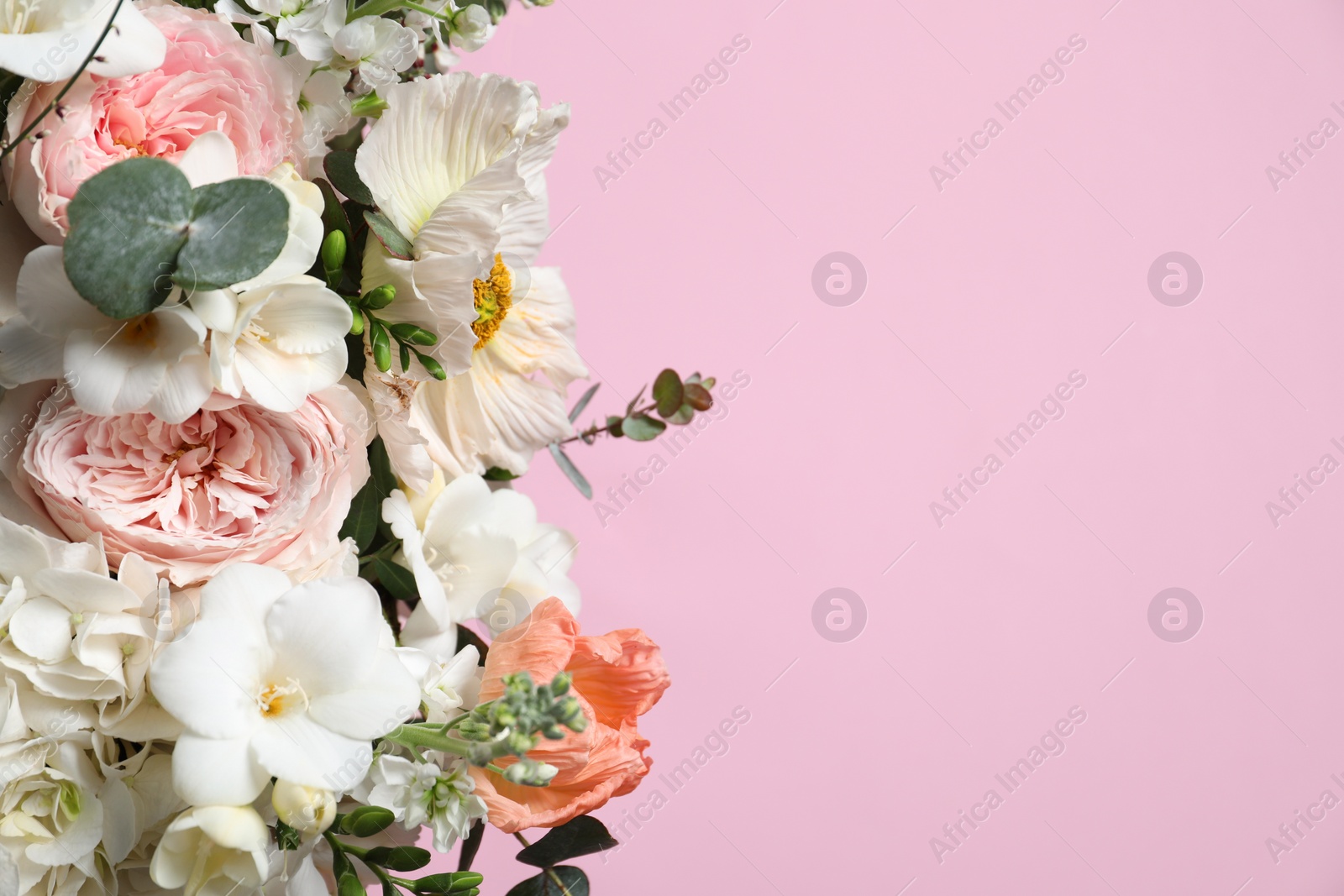 Photo of Bouquet of beautiful flowers on pink background, closeup. Space for text