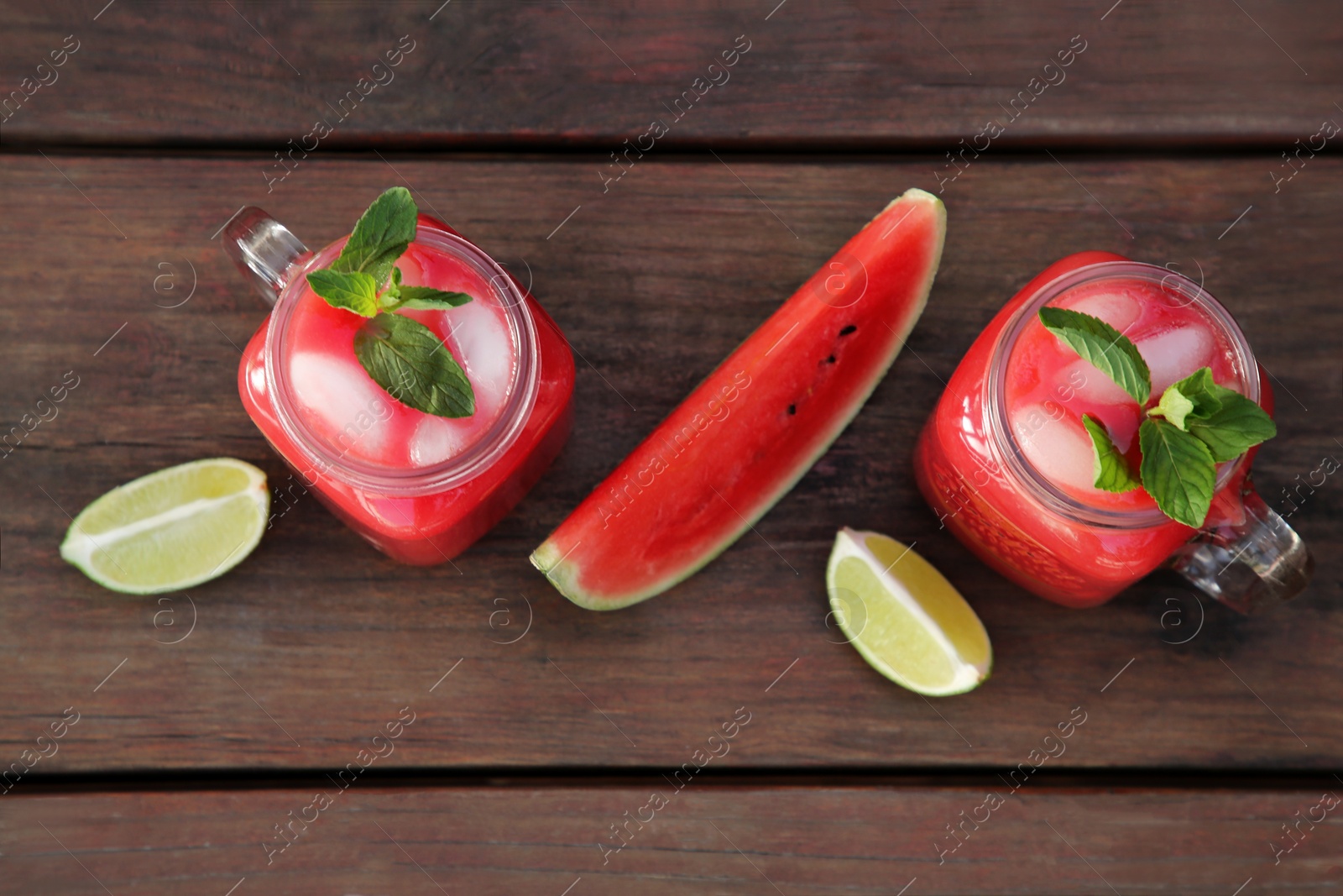 Photo of Delicious watermelon drink and fresh fruits on wooden table, flat lay