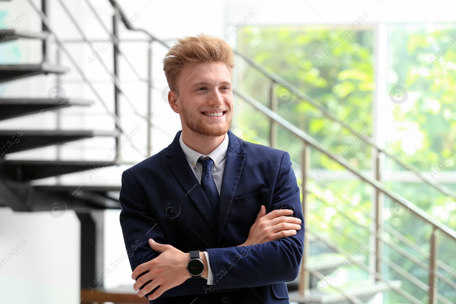 Photo of Portrait of handsome young man in elegant suit indoors