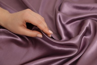 Photo of Woman touching smooth silky fabric, closeup view