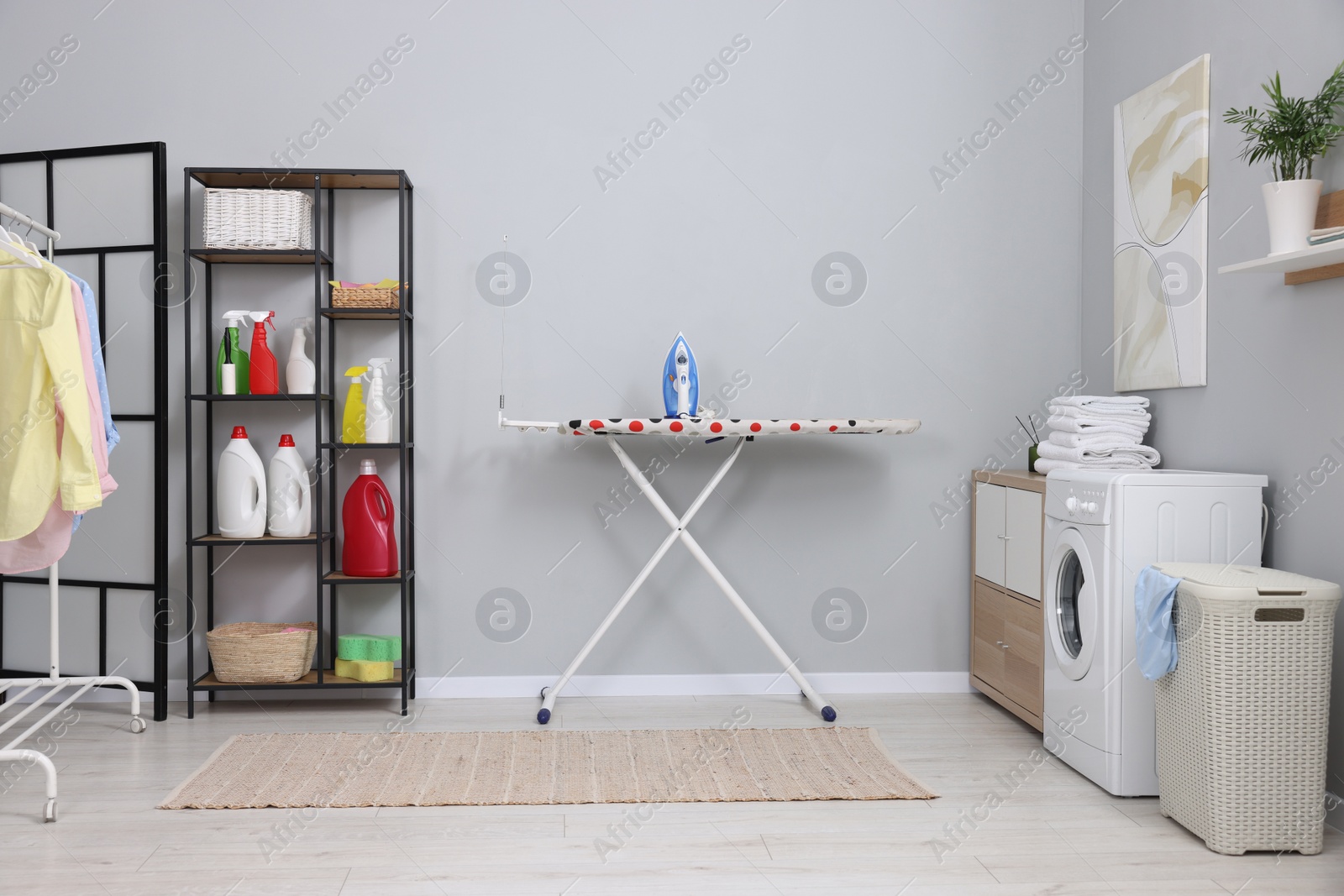 Photo of Laundry room interior with washing machine and furniture