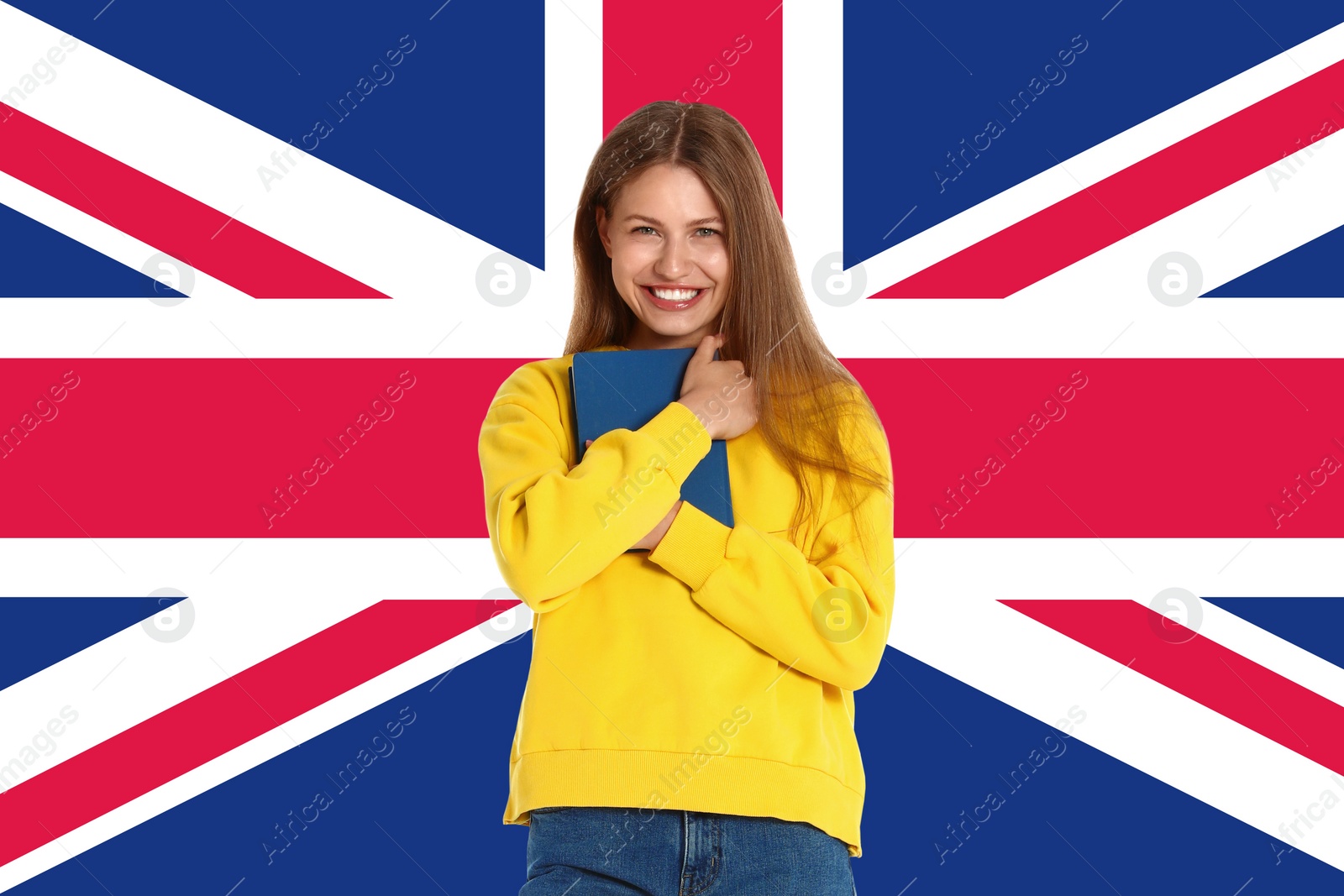 Image of Beautiful young woman with book and flag of Great Britain as background. Learning English