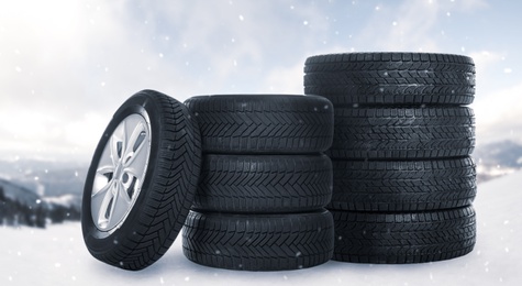 Set of wheels with winter tires outdoors on snow