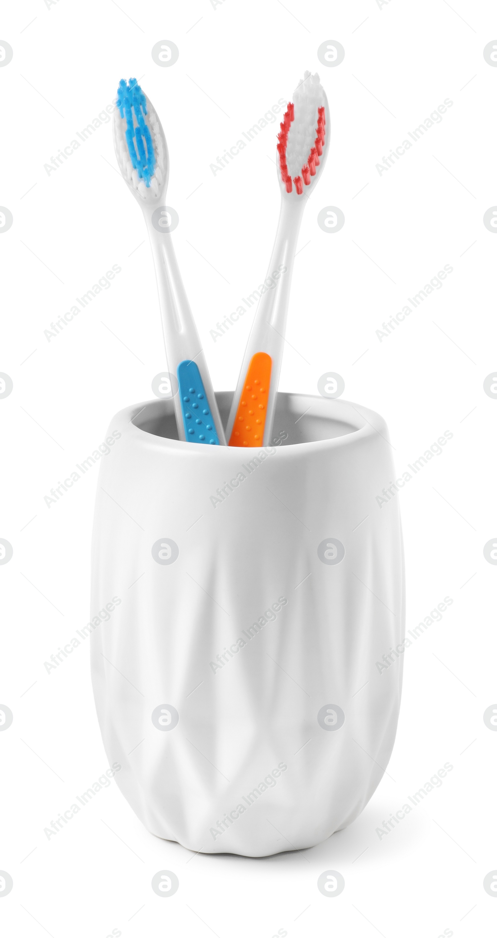 Photo of Bath accessories. Toothbrushes in holder isolated on white