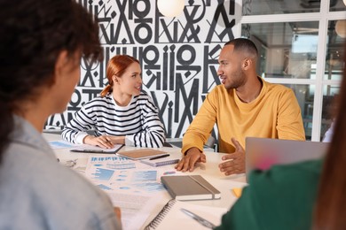 Team of employees working together at table in office. Startup project