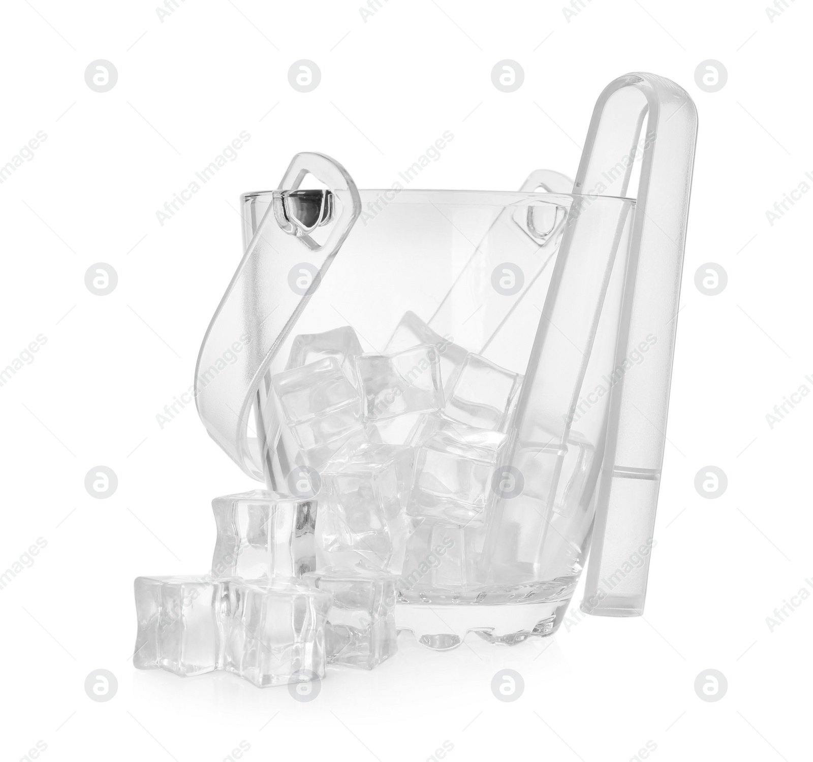 Photo of Glass bucket with ice cubes and tongs on white background