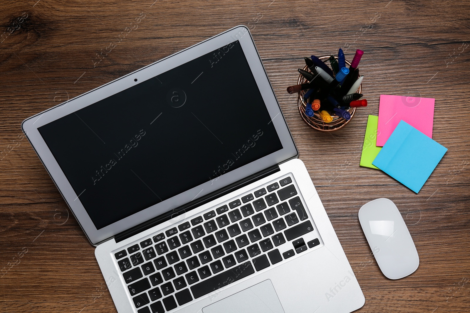 Photo of Modern laptop and office stationery on wooden table, flat lay. Distance learning