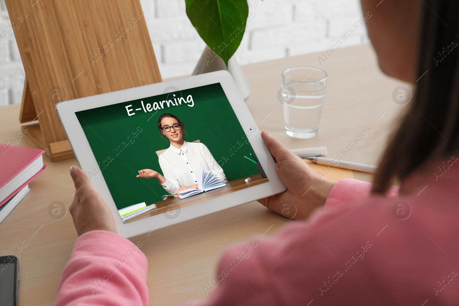 Image of Young woman using tablet for online studying at home, closeup