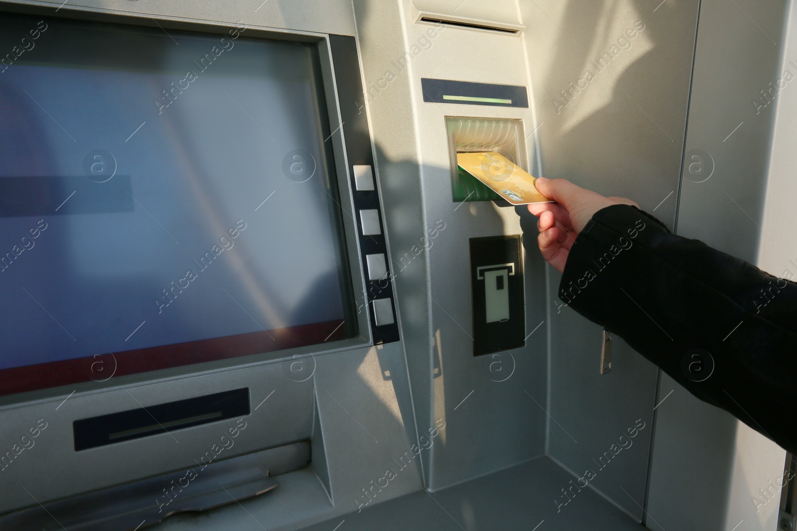 Photo of Woman using cash machine for money withdrawal outdoors, closeup