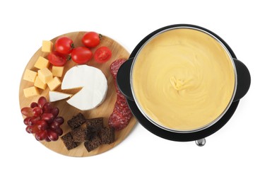 Photo of Fondue with tasty melted cheese and different snacks isolated on white, top view