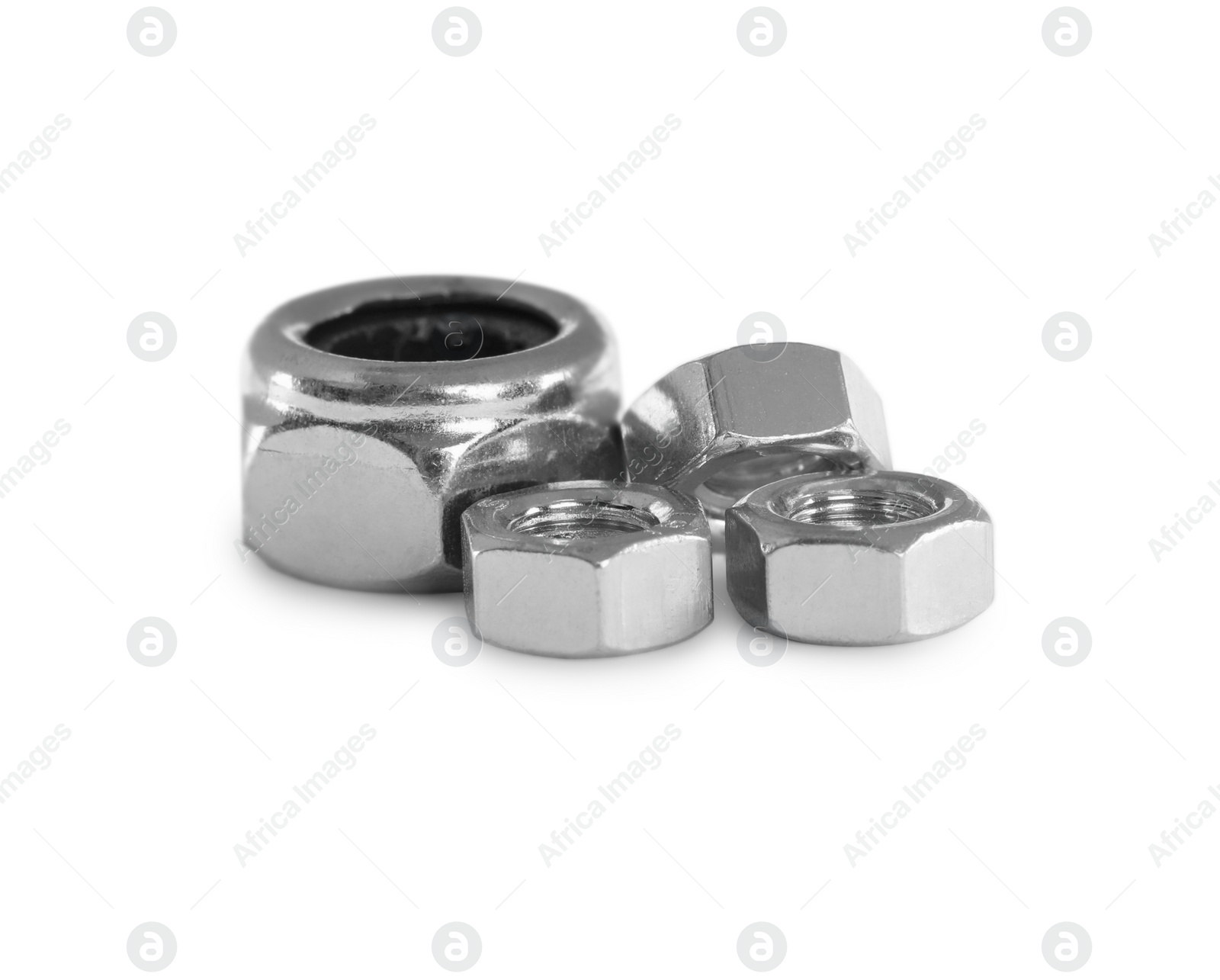 Photo of Different metal hex nuts on white background