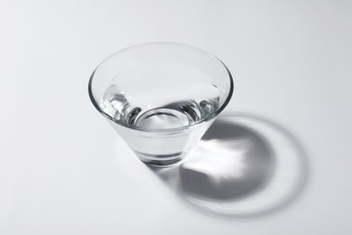 Photo of Glass bowl with water on white background