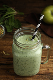 Tasty green buckwheat smoothie on wooden table