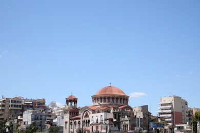 PIRAEUS, GREECE - MAY 19, 2022: Picturesque view of city street with beautiful buildings on sunny day