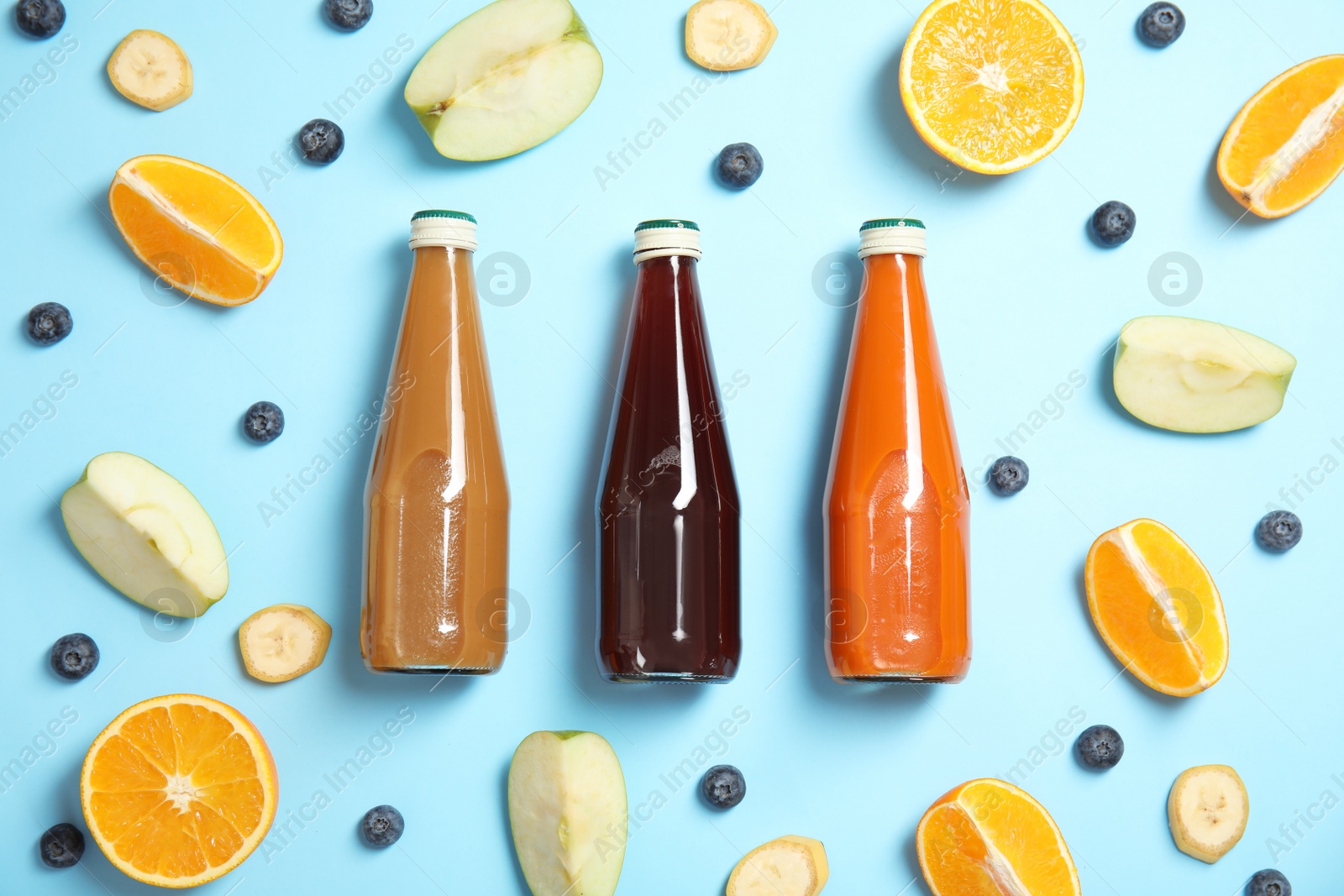 Photo of Flat lay composition with different drinks in bottles and ingredients on color background