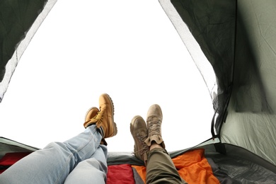 Photo of Closeup of couple in camping tent on white background, view from inside