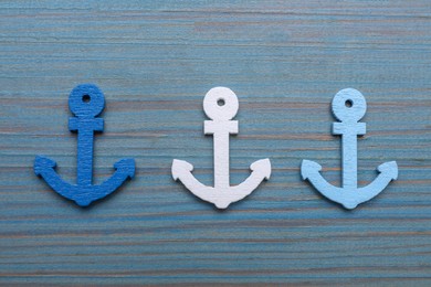 Anchor figures on light blue wooden table, flat lay