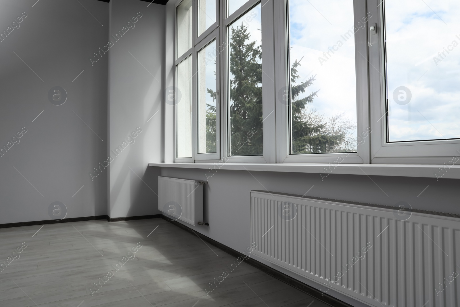 Photo of Modern office with window and radiators. Interior design