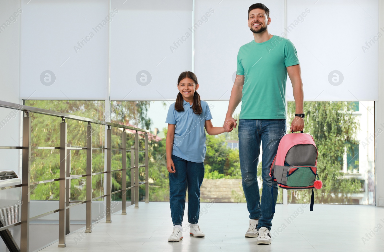 Photo of Father with his little daughter in school hall