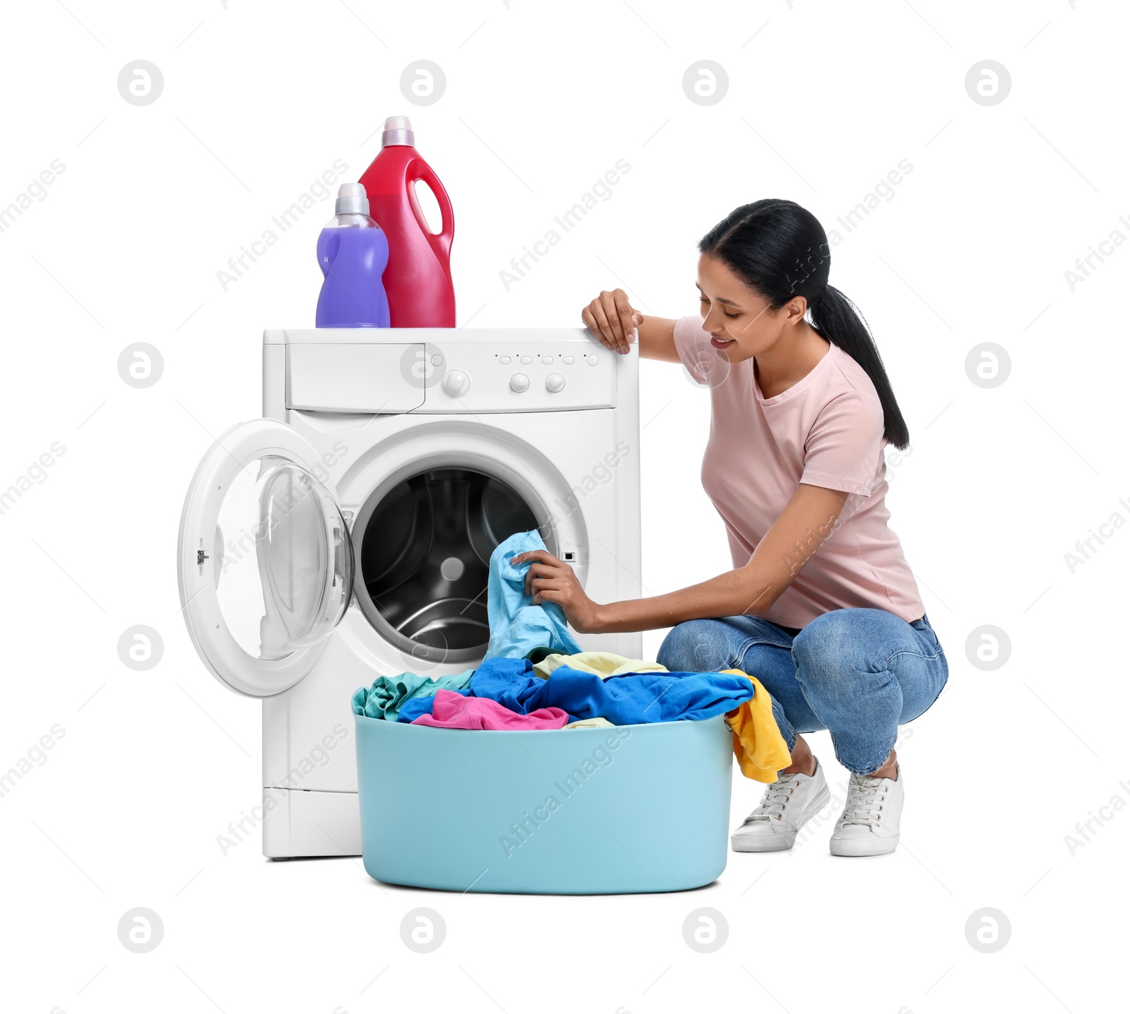 Photo of Beautiful woman with laundry basket near washing machine on white background