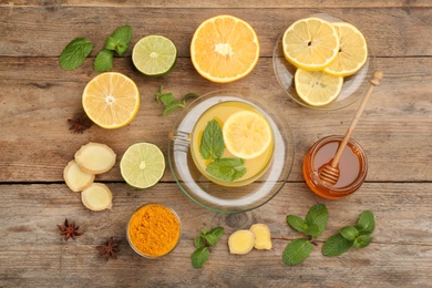 Flat lay composition with immunity boosting drink and ingredients on wooden table