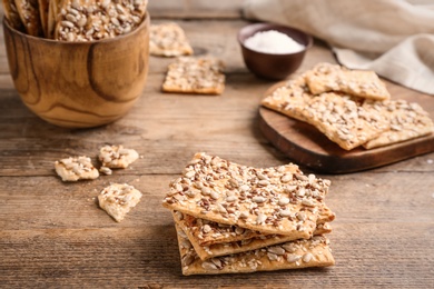 Photo of Stack of delicious crackers on wooden table