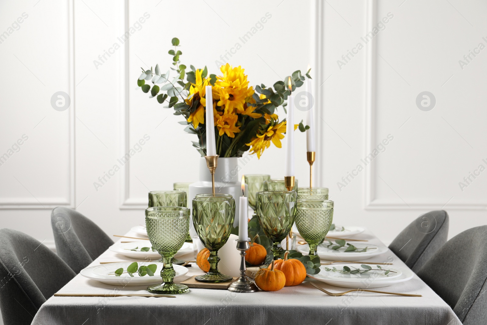 Photo of Beautiful autumn table setting with bouquet indoors. Plates, cutlery, glasses and floral decor