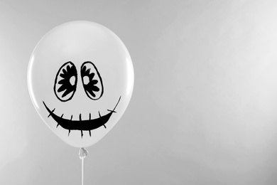 Photo of Spooky balloon for Halloween party on light grey background, space for text