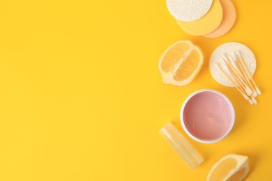 Photo of Lemon face cleanser. Fresh citrus fruits and personal care products on yellow background, flat lay with space for text