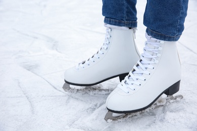 Photo of Woman wearing figure skates on ice rink, closeup