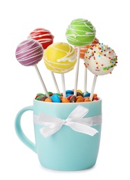 Photo of Delicious colorful cake pops in cup on white background