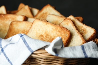 Slices of toasted bread in basket, closeup