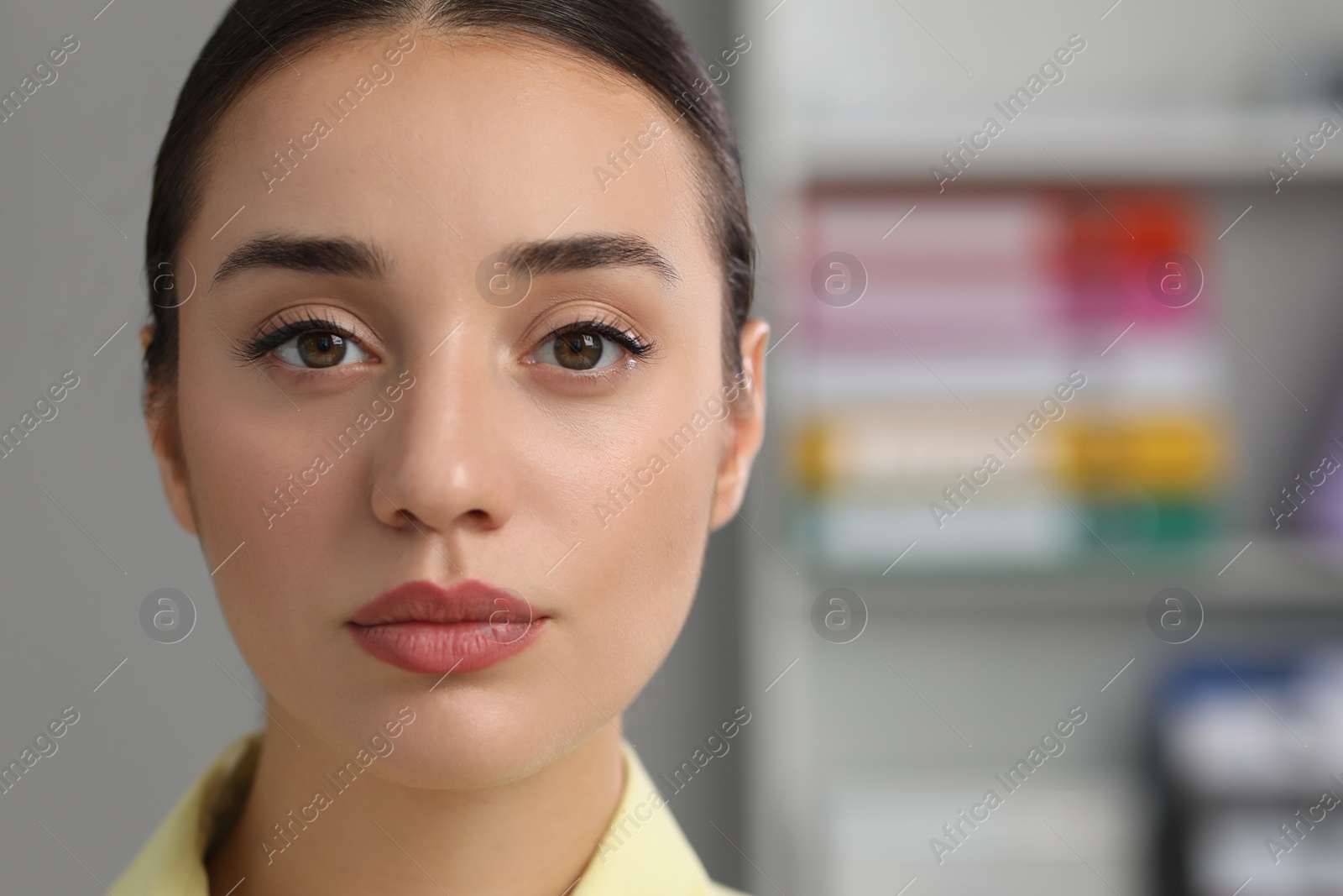 Photo of Portrait of beautiful young woman in office, closeup. Space for text
