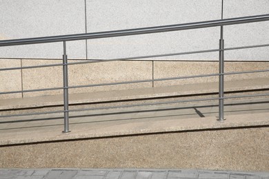 Photo of Ramp with metal handrail near building outdoors